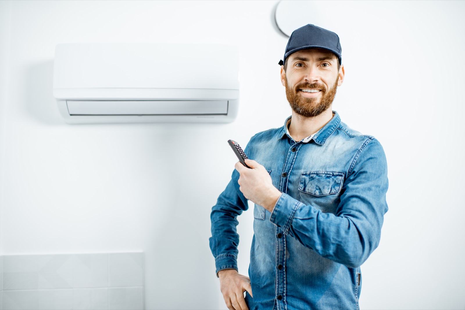 A Brightline technician adjusting an indoor AC unit