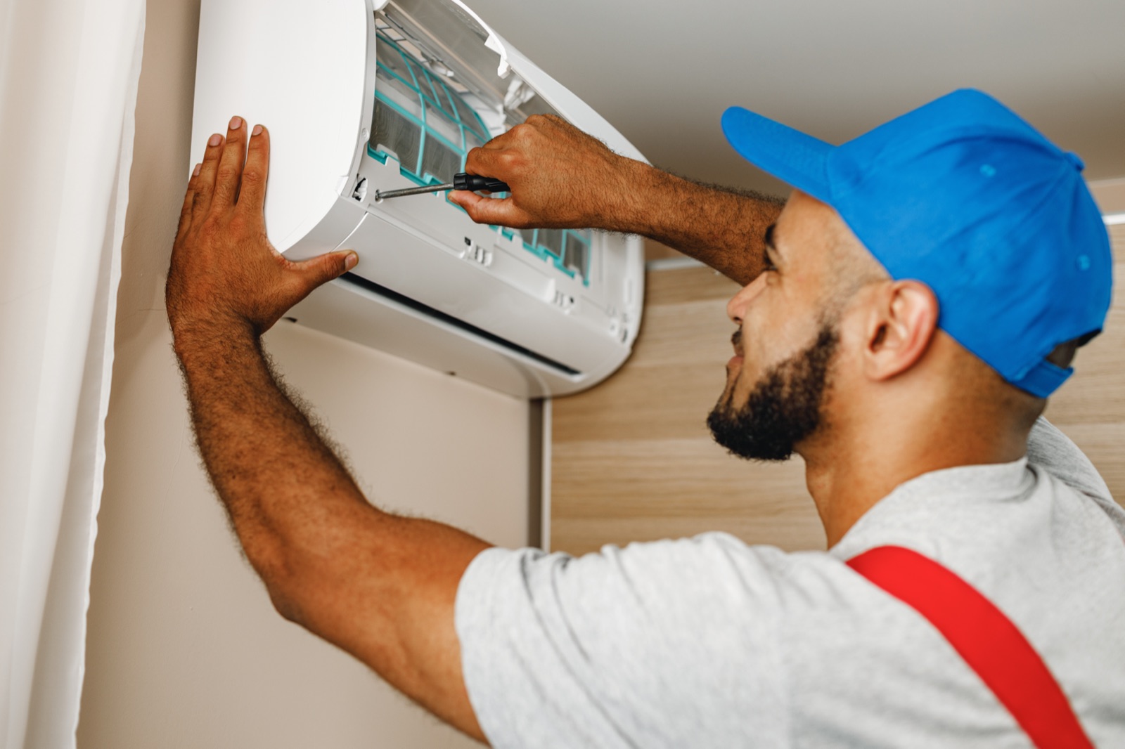 Repairman installing an air conditioner