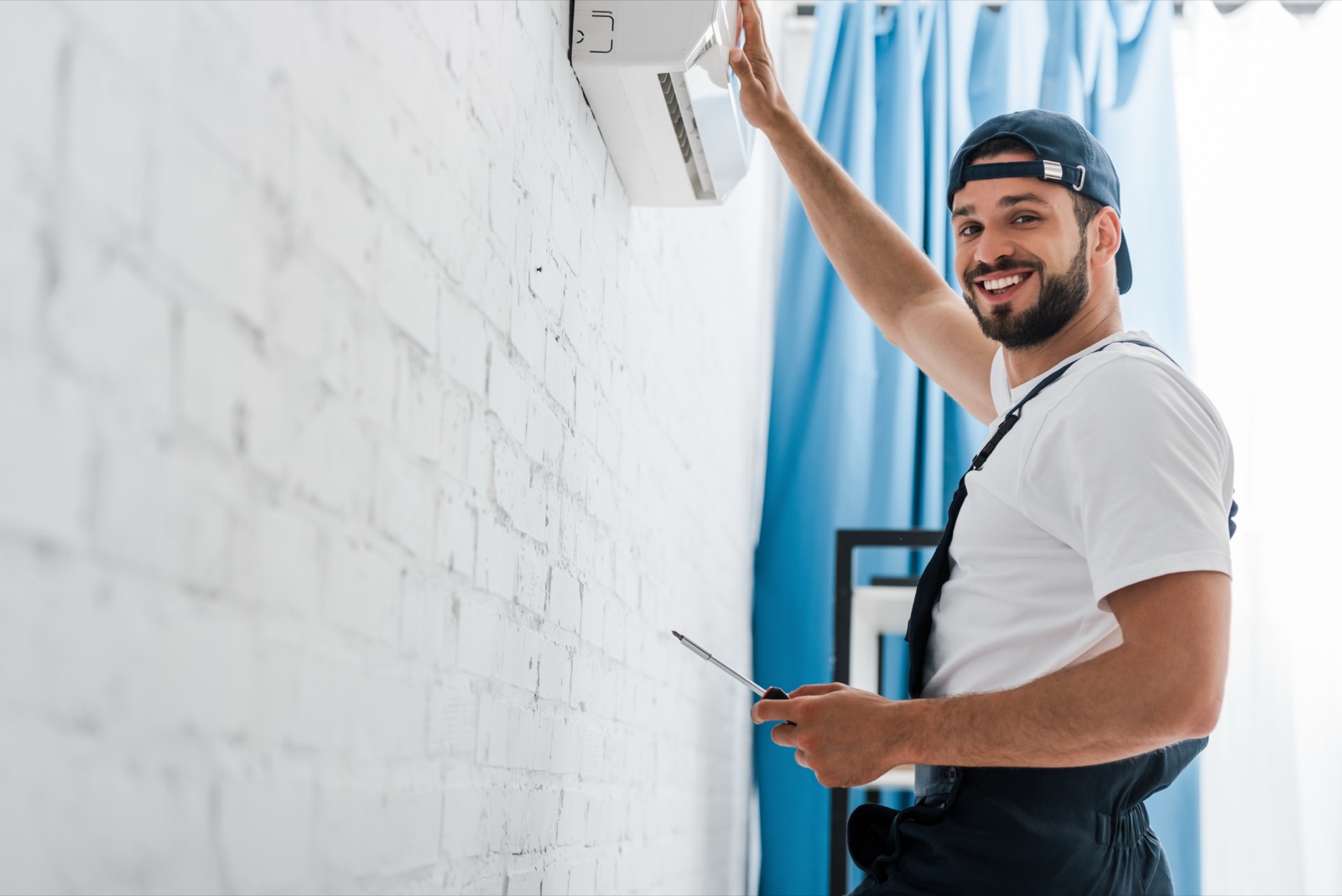Brightline technician repairing a residential air conditioner