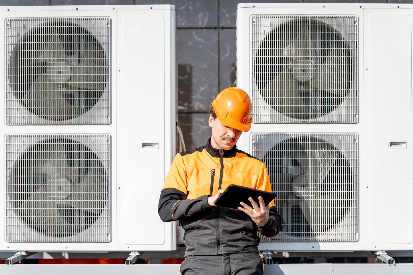 Technician servicing a heat pump